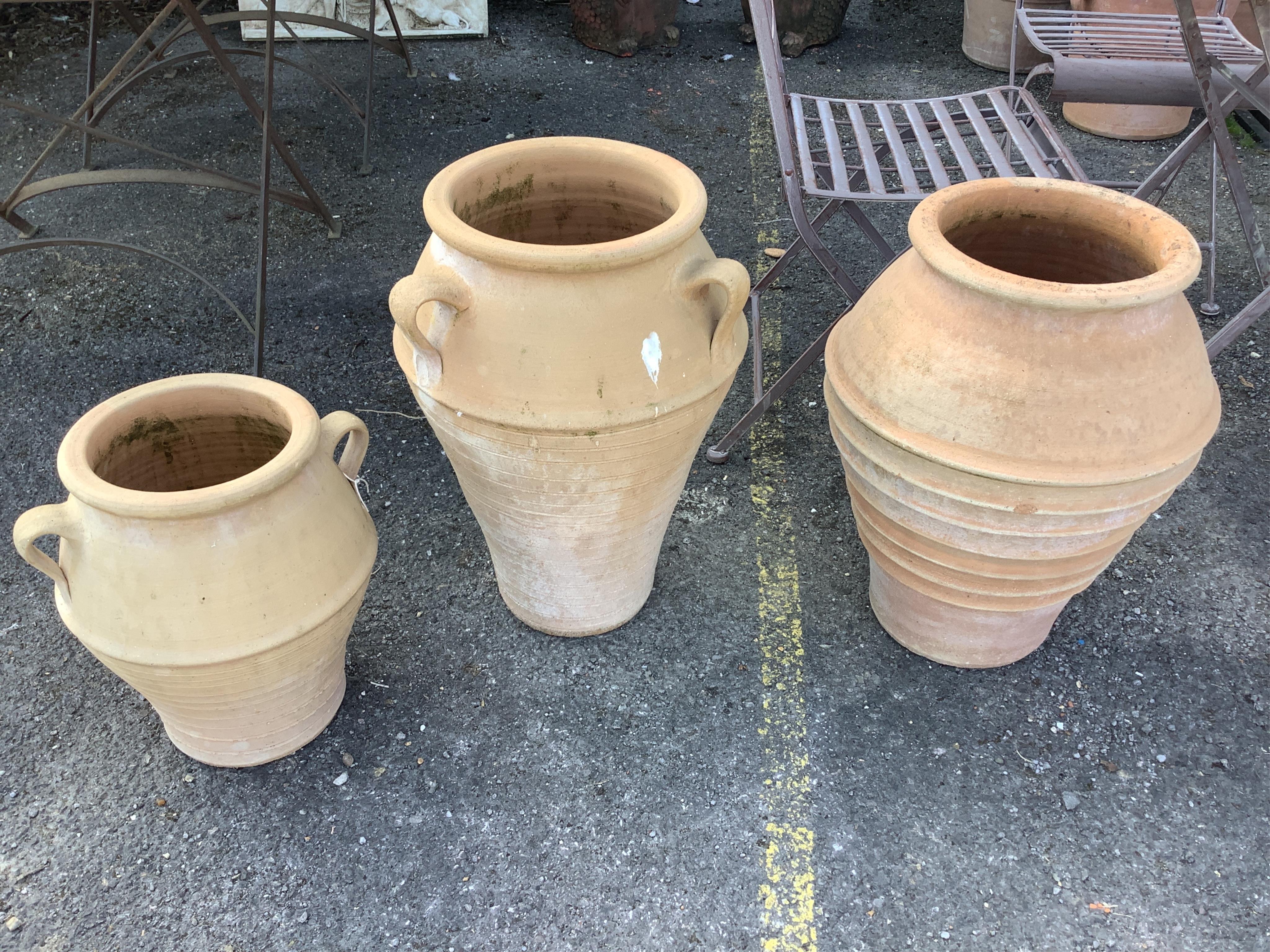Three Grecian style circular terracotta garden planters, height 55cm